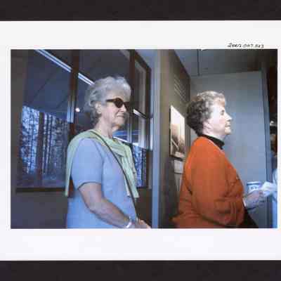 Photograph of two women at Springfield Museum's "Working in the Woods" Exhibit, Springfield, Oregon, 2000