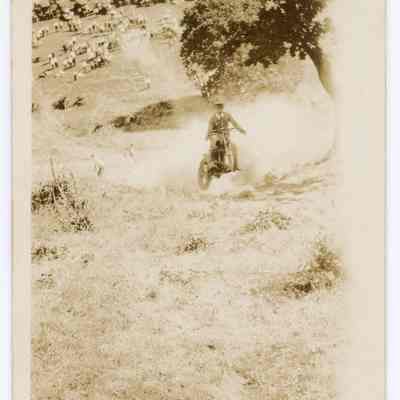 Photograph of a motorcyclist on a hill climb, undated