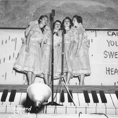 Photograph of four unknown women singing at barbershop parade, 1954