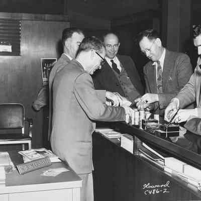 Photograph of six men counting money from Rotary Barbershop Quartet Parade, 1951