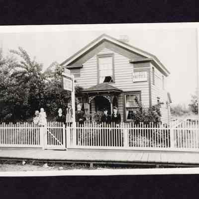 Photograph of 7 People in front of Clark Hotel, 1912