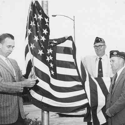 Photograph of American Legion members raising the flag, date unknown
