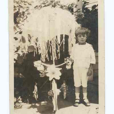 Photograph of a little boy and a tricycle, undated