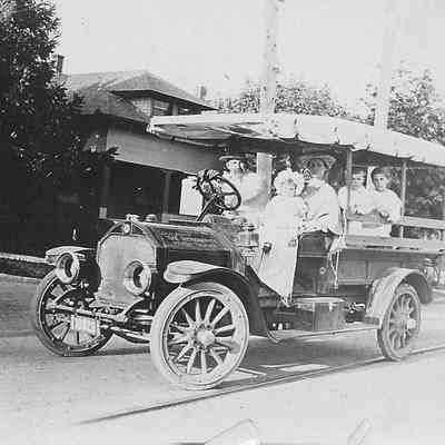 Photograph of Ross Matthew and his family in an early truck/automobile, circa 1914-15