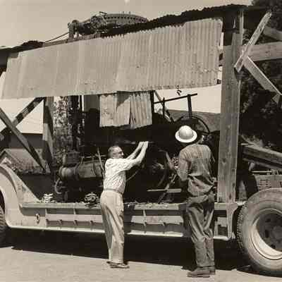 Photograph of Workers inspecting Equipment, Undated