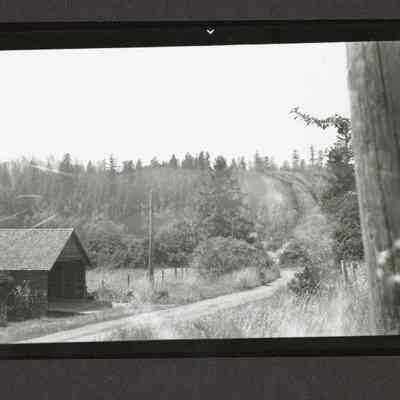 Photograph of s House on country road from a distance, date unknown