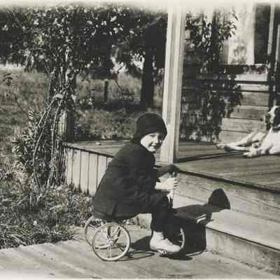 Little Anderson child on tricycle.