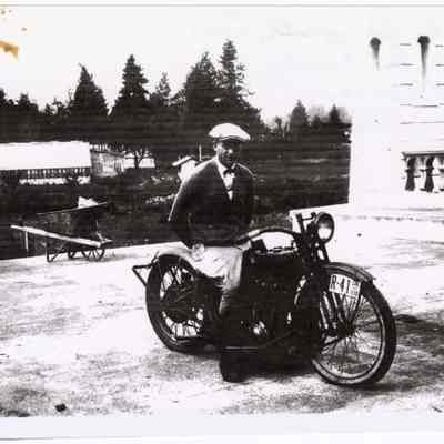 Photograph of Bill Davis on his motorcycle, bridge in Springfield, 1926