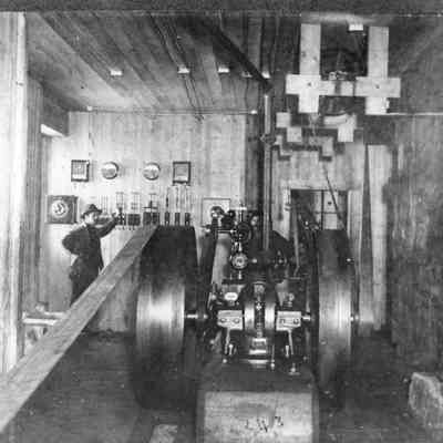 Photograph of two men behind the electric belt drives at Booth-Kelly Mill, Wendling, Oregon