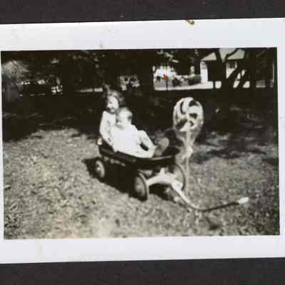 Photograph of children in a Mercury wagon, circa 1950