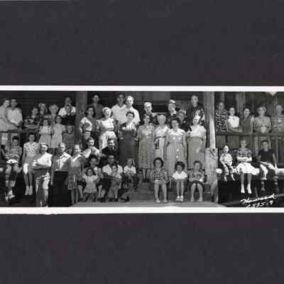 Photograph of a large group of people on a porch, Unknown date and location