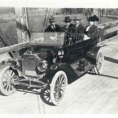 Photograph of a car with the Mountjoy family, wooden bridge, Springfield, Oregon, 1915