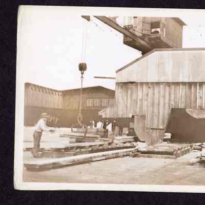 Photograph on postcard of timber, flitch and cant dump at Jones Lumber Company, Portland, Oregon, date unknown