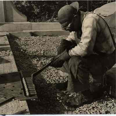 Photograph of welder at work on bridge, date unknown.