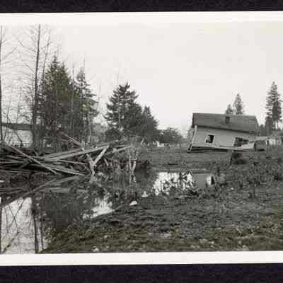 Photograph of a House and Outbuildings Damaged in a Flood, Date Unknown.