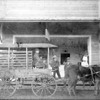 Photograph of a group of unknown people outside the Perkins and Demorast Market