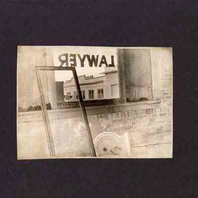 Photograph, Dilapidated building looking out window, date and location unknown.