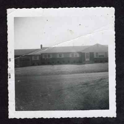 Photograph of a one-story house and garage, 1964