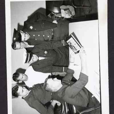 Photograph, Firemen Looking at a Book, Undated