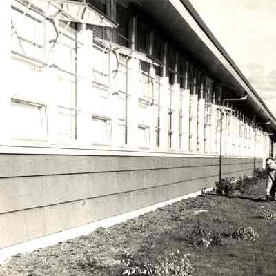 Photograph of Principal Everett Snyder beside Page Elementary, Springfield, Oregon, date unknown.