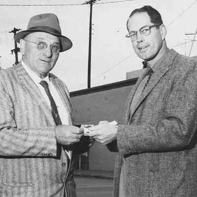 Photograph of Rotary Club members exchanging money, date unknown
