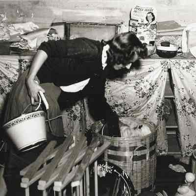 Photograph of an unidentified women looking for something at Springfield High Carnival Setup, Springfield, Oregon, circa 1940s
