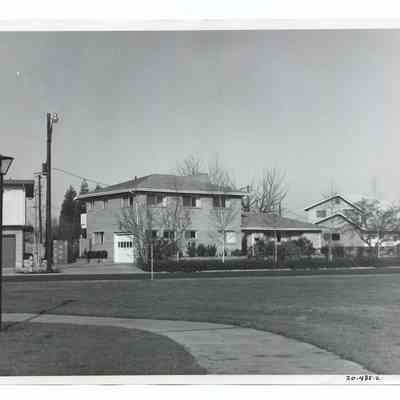 Photograph of a brick house with a hip roof, Springfield, circa 1960