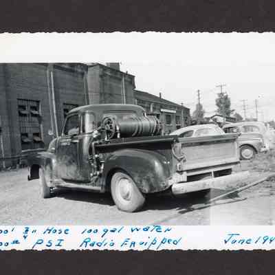 Photograph of truck with hose