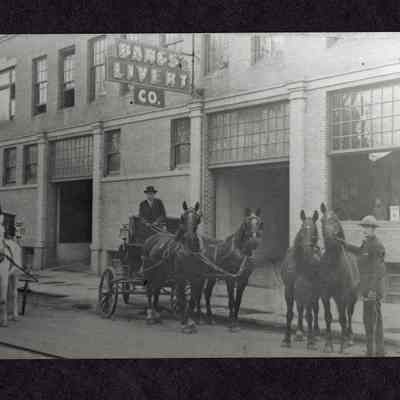 Photograph of horses and wagons on the street outside Bangs Livery Co, Eugene, Oregon