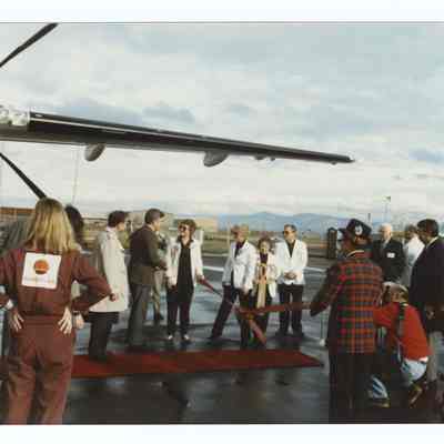 Photograph of a ribbon cutting at an airport, circa 1990