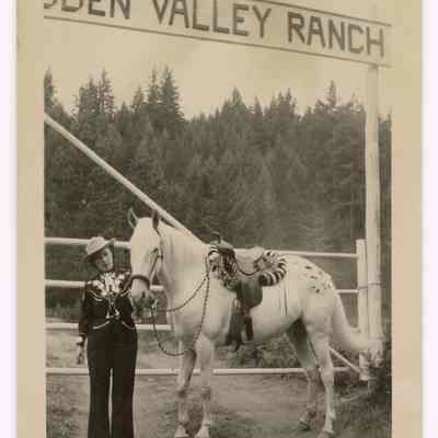 Photograph of Etta Davis and ranch sign, Hidden Valley Ranch, Oregon, undated