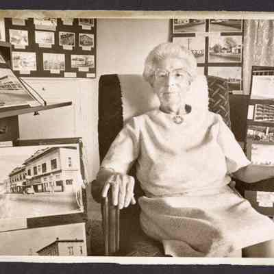 Photograph, Crystal B. Fogle with photo collection.