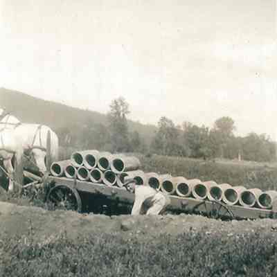 Photograph of Pipes being laid for drainage by Ernie Berg, Undated