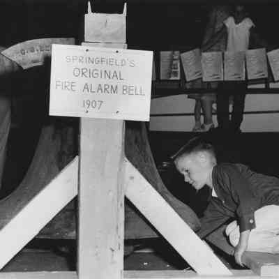 Photograph of Springfied's original fire alarm bell from 1907, on display at Shoppers Paradise, Springfield, Oregon, 1957