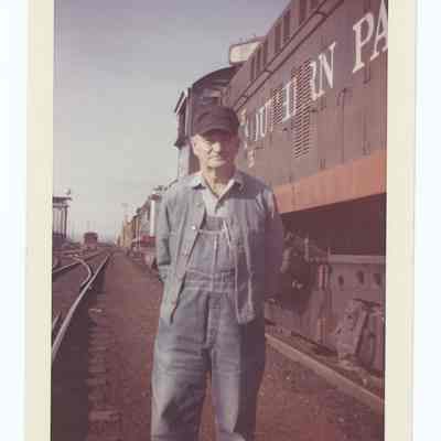 Photograph of Harry Fox next to South Pacific train '5220', undated