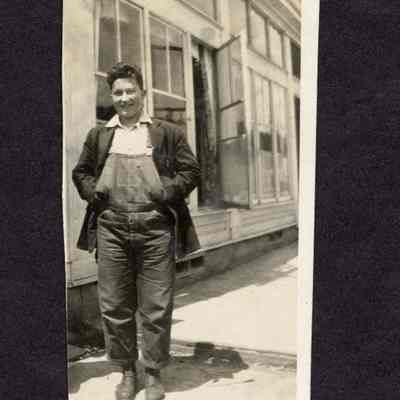 Photograph of unknown man in overalls and a suit jacket