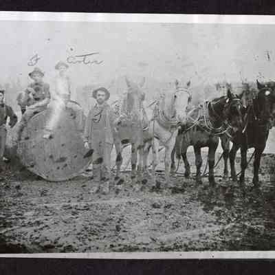 Photograph of four person logging crew with horse team
