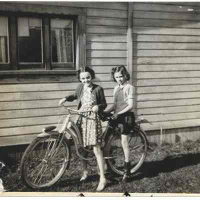 Photograph of Two Girls and a Bicycle, Undated