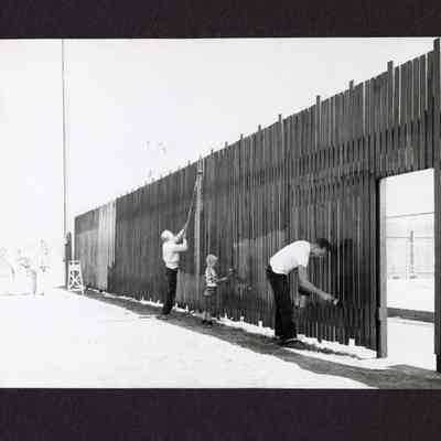 Photograph, Men and Child Painting Fence, Date Unknown.