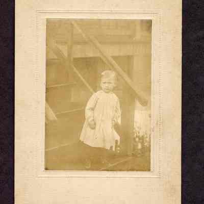 Photograph of little child at the bottom of some stairs