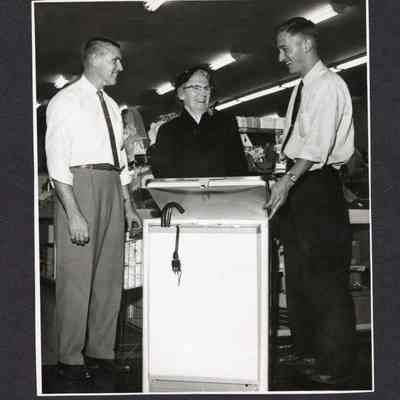 Photograph of 2 men and Crystal Fogle, unknown date and location