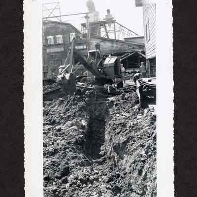 Photograph of excavator picking up dirt at Booth-Kelly Lumber mill drainage construction site, Springfield, Oregon, 1948