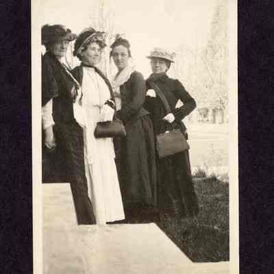 Photograph of four women in dresses