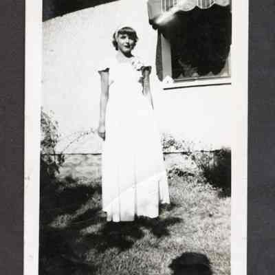 Photograph of a young woman in a long dress, undated
