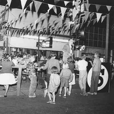 Photograph of speaker at Shoppers Paradise event, Springfield, Oregon, 1957.