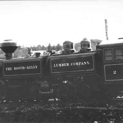 Photograph of six unidentified men posing with a Booth-Kelly Engine, Wendling, Oregon, circa 1910