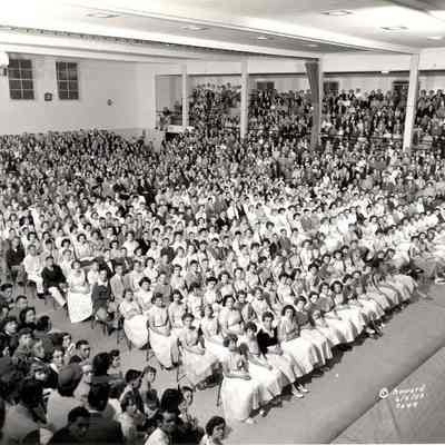 Photograph of students and guests in high school gym, 1953