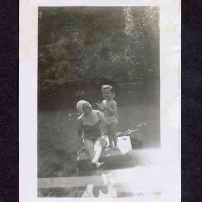 Photograph of a woman and a child swimming in a river, 1950