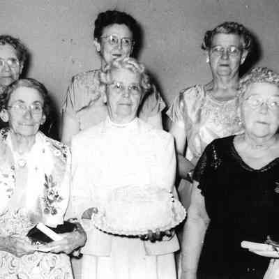 Photograph of six women at Masonic Lodge, one holding a cake, date unknown