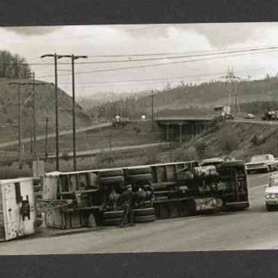 Photograph of semitrailer on side, blocking traffic in Goshen area, undated